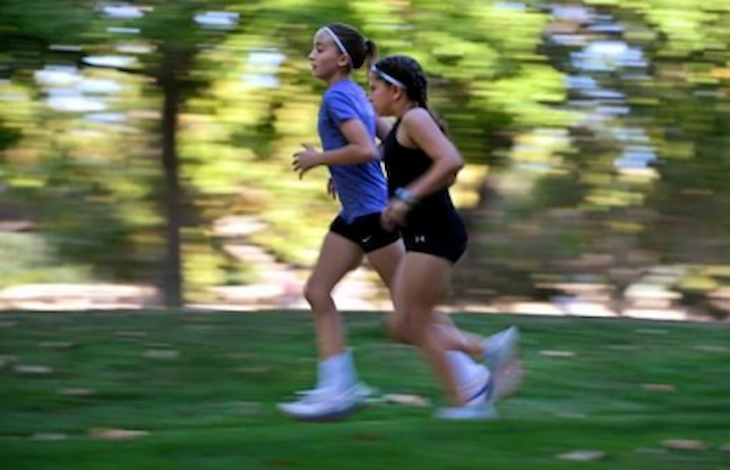 Two people running side-by-side